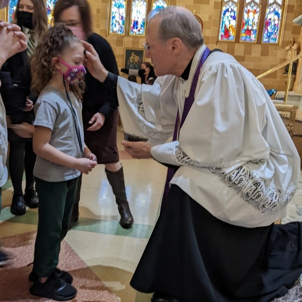 Father Tim gives out ashes.