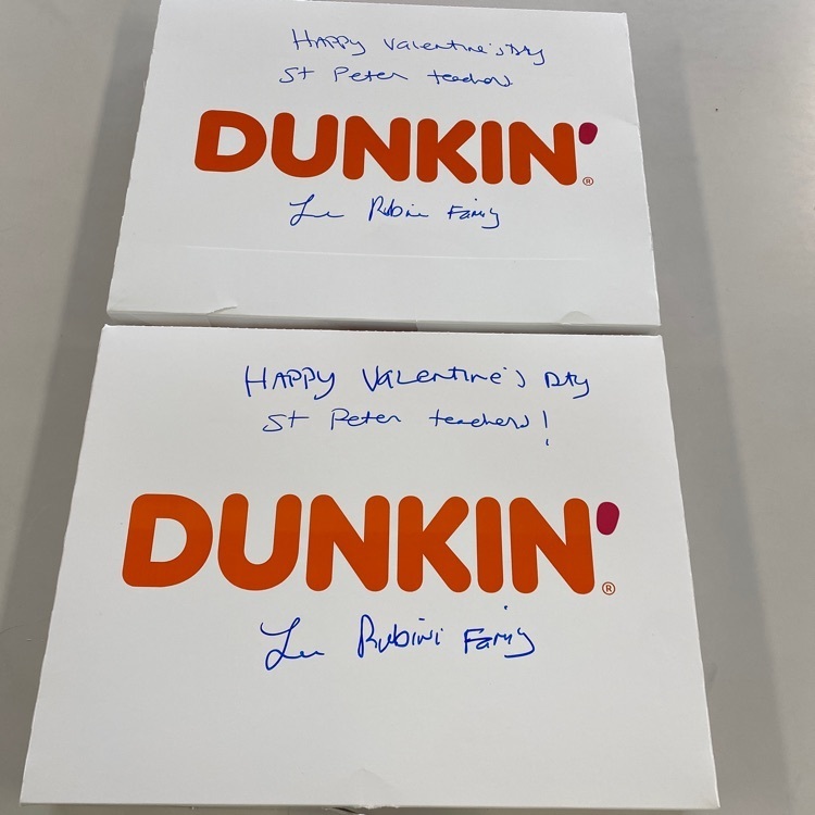 two boxes of Dunkin Donuts boxes with the words “Happy Valentine’s Day Saint Peter Teachers! Lee Rubini family” handwritten